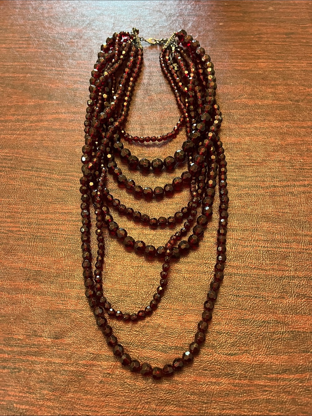 Vintage 7-stranded garnet-colored beaded necklace. A true statement piece!